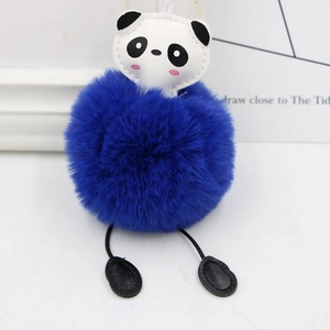 Detail of cute panda plush keychain with soft navy blue faux fur ball and leather accents