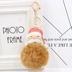 Detail of Santa Claus leather charm with a large brown fluffy faux fur pompom keychain