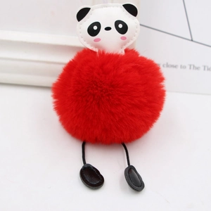Close-up of fluffy red panda pompom keychain with soft faux fur and leather details