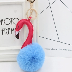 Detailed close-up of pink leather flamingo neck and light blue faux fur pompom keychain