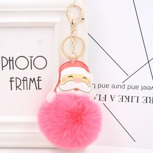 Detailed view of Santa Claus leather charm with bright rose pink faux fur pom pom keychain