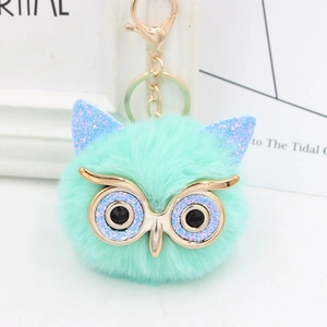 Detailed view of mint green sequin owl plush keychain with golden lobster clasp and rings