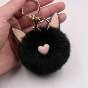 Gros plan du porte-clés chat en peluche noire avec cœur rose et fermoir doré