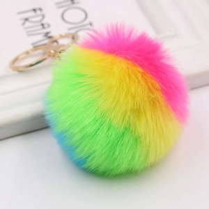 Detail of colorful faux fur rainbow keychain with gold lobster clasp and plush texture