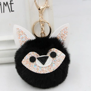 Close-up of black plush fox keychain with sparkling sequins and gold metal lobster clasp