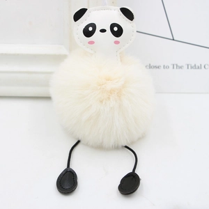 Detail of cute panda plush pom pom keychain with faux fur texture on white background