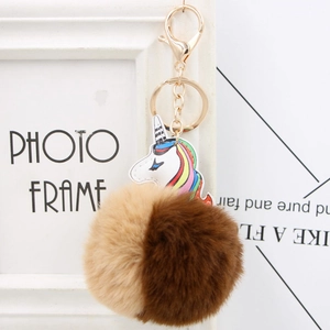 Detailed close-up of a two-tone faux fur pompom with a PU leather unicorn keychain