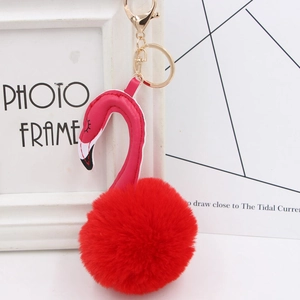 Detail of flamingo keychain with red faux fur pompom and gold lobster clasp for bags