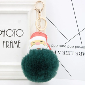Detail of dark green pom-pom Santa keychain with leather face and gold lobster clasp