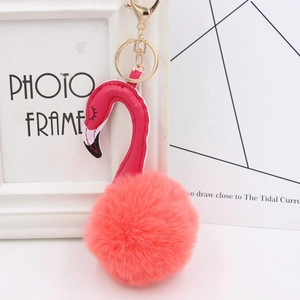 Detailed view of pink plush flamingo keychain with gold metal clasp and soft pom pom