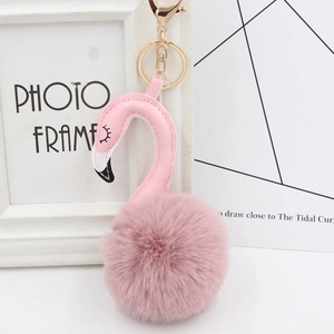 Detail of pink plush flamingo keychain with golden lobster clasp and soft faux fur ball