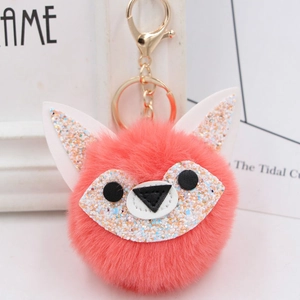 Close-up of fluffy fox head keychain with glitter ears and golden metal clasp details
