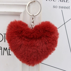 Macro view of fluffy red heart-shaped plush keychain with a metallic silver ring and chain