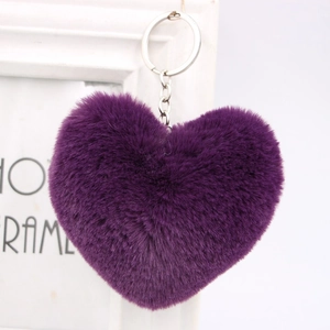 Detailed view of heart-shaped purple faux fur keychain with silver metal ring on white frame