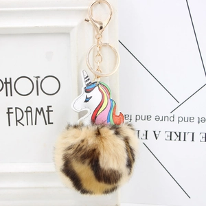 Detail of colorful unicorn PU leather pendant with leopard print pompom and gold keychain