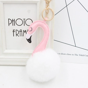 Close-up of pink flamingo keychain with white faux fur pompom and gold lobster clasp