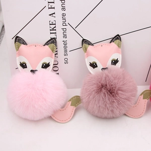 Detail view of pink fluffy faux fur fox keychains with soft texture and PU leather details