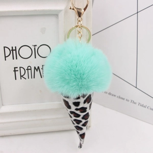 Detail of mint green faux fur pom-pom ice cream keychain with leopard print cone