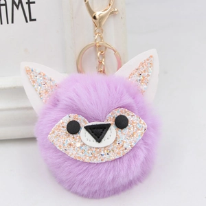 Detailed view of purple faux fur fox keychain with glitter ears and golden metal clasp