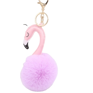 Pink plush flamingo keychain with gold metal ring and lobster clasp on white background