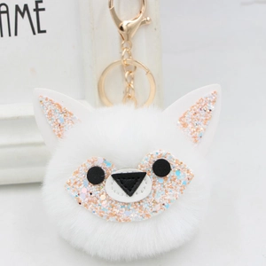 Sparkly fox pompom keychain in white faux fur with sequin details and golden ring