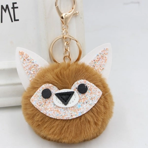 Close-up of fluffy brown fox plush keychain with sparkling sequins and golden lobster clasp
