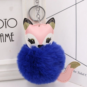 Detail of cute fox keychain featuring vibrant blue faux fur pom-pom and pink leather