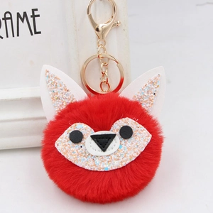 Detail of red plush fox keychain with sparkling sequins and gold metal hardware link