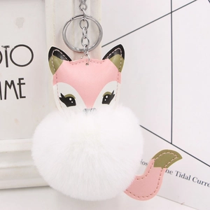 Detailed close-up of a fox plush ball keychain with high-density faux fur and leather details