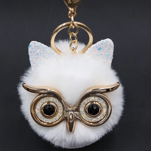 Detailed view of plush owl keychain with sequins and high-quality gold hardware