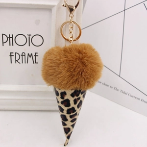 Detail of soft brown faux fur pom pom and leopard print ice cream cone keychain with gold clip