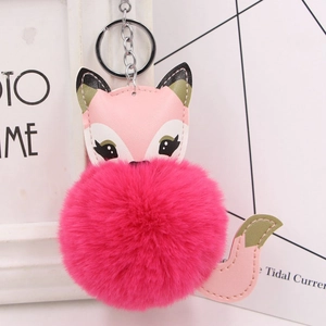 Close-up of cute rose red faux fur fox pompom keychain with silver metal clip and pink leather
