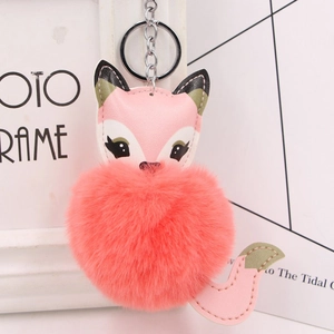 Close-up of a pink fox plush pompom keychain with faux leather ears and silver ring