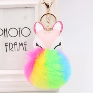 Detail of cute PU leather fox head with a soft rainbow gradient fluffy pompom keychain