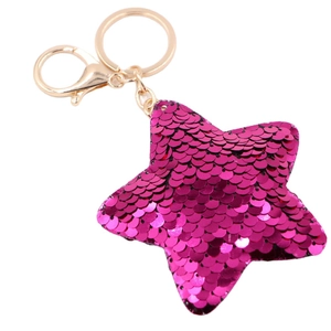 Sparkling magenta star shaped sequin keychain with gold lobster clasp on white background