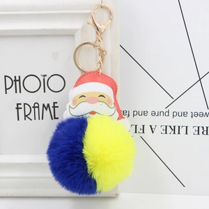 Porte-clés Père Noël avec pompon en fourrure bleu et jaune et anneau doré chic