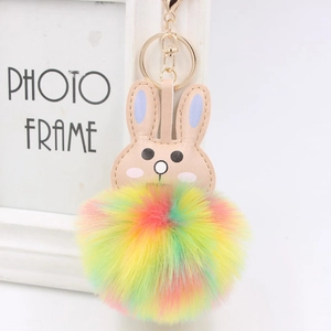 Detail of colorful faux fur rabbit keychain with golden alloy ring and lobster clasp