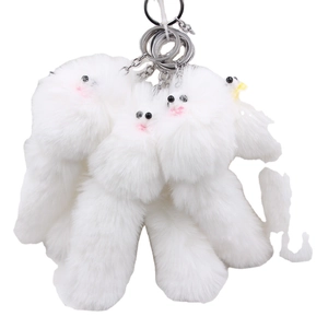 Three white fluffy plush bird-shaped keychains with glossy faux fur and metal rings