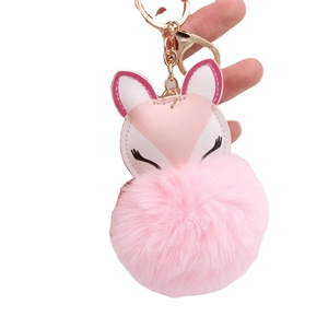 Pink fox faux fur pompom keychain with gold metal clasp and soft plush texture