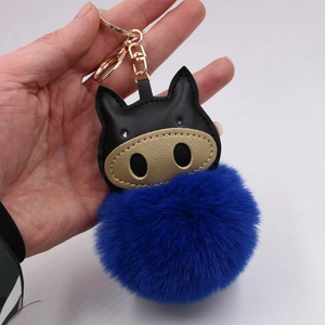 Royal blue plush ball keychain with black leather pig charm and gold lobster clasp