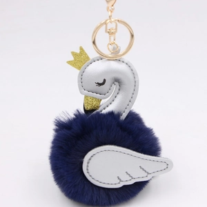 Detailed close-up of swan plush keychain with silver leather and blue pom-pom