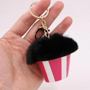 Creative cupcake pom pom keychain with black faux fur top and pink striped base
