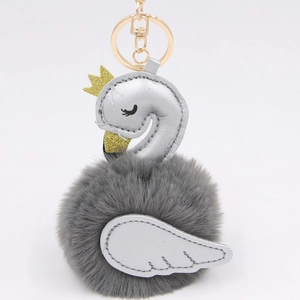 Detailed view of grey faux fur swan keychain with silver PU leather and gold hardware
