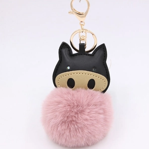 Detail of creative plush pig keychain with pink fur ball and black leather pig head