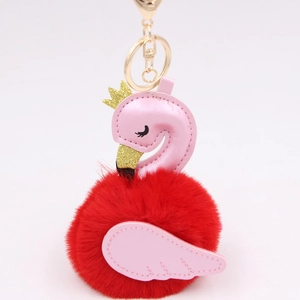 Detail of red faux fur flamingo keychain with pink PU leather and golden crown