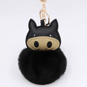 Cartoon pig plush keychain with black faux leather and golden snout on white background
