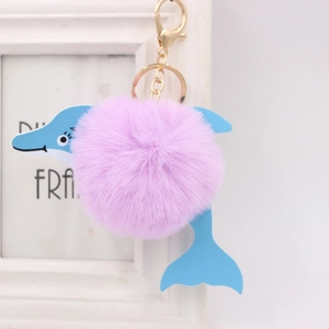Close-up of pink plush dolphin keychain with golden lobster clasp on a white background