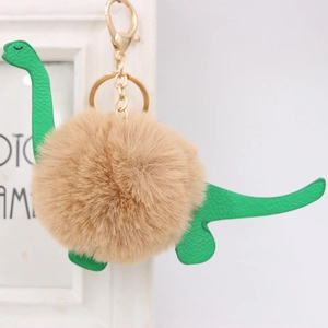 Cute green dinosaur plush pom-pom keychain with soft faux fur and gold metal hardware