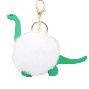 Green leather dinosaur plush ball keychain with golden metal clasp on white background