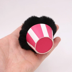 Cupcake pompom keychain with black plush ball and pink striped cone base hand-held